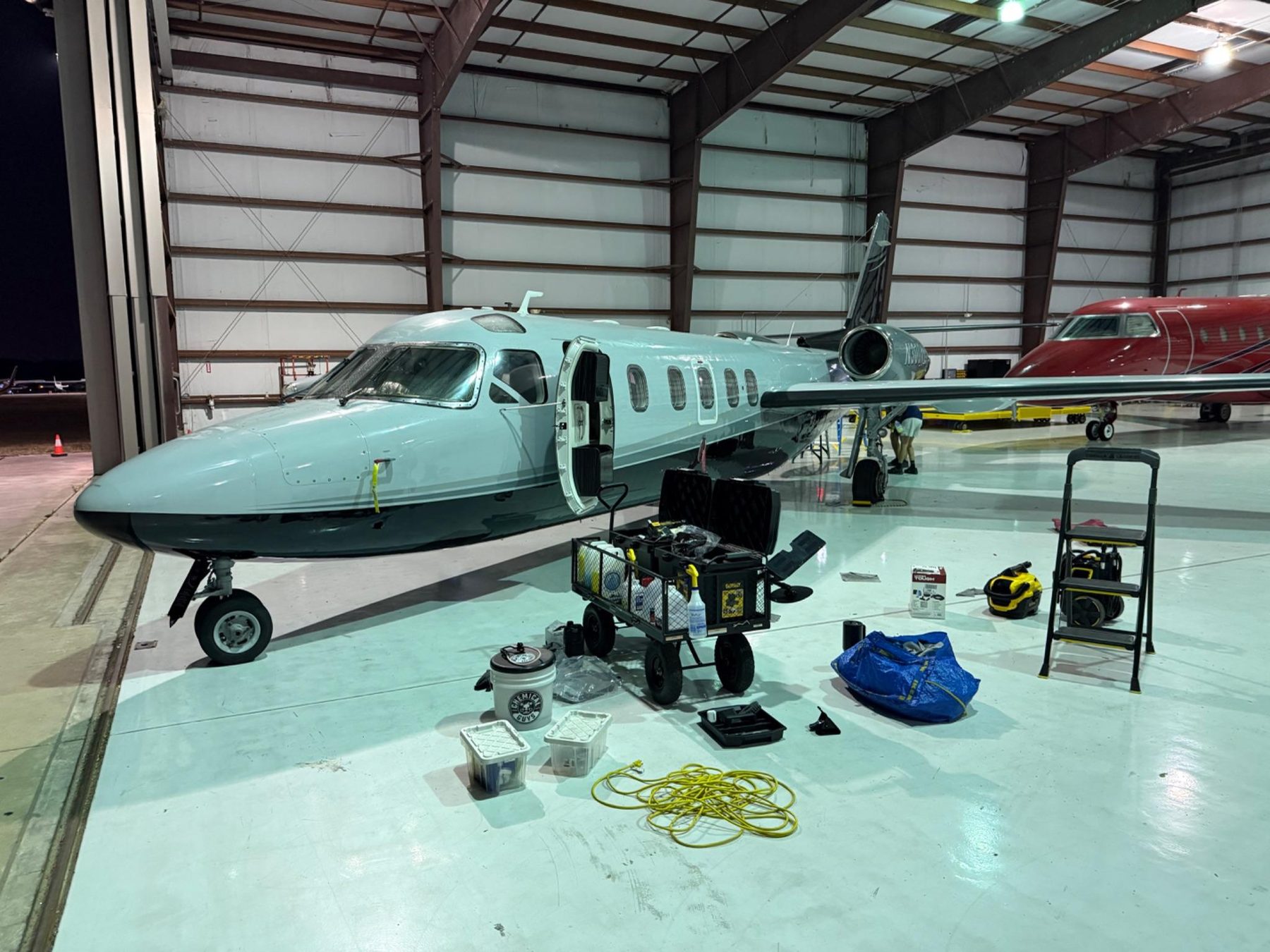 Jet detailing setup at night with full equipment cart
