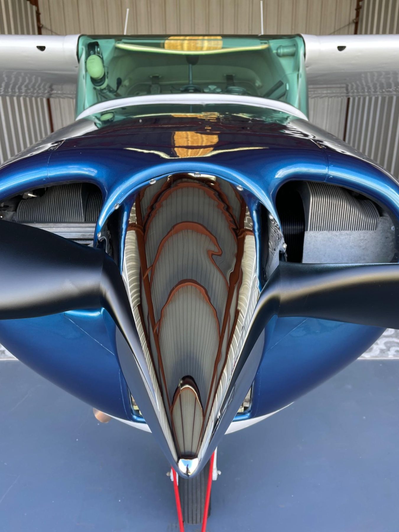 Polished blue vintage aircraft nose and propeller